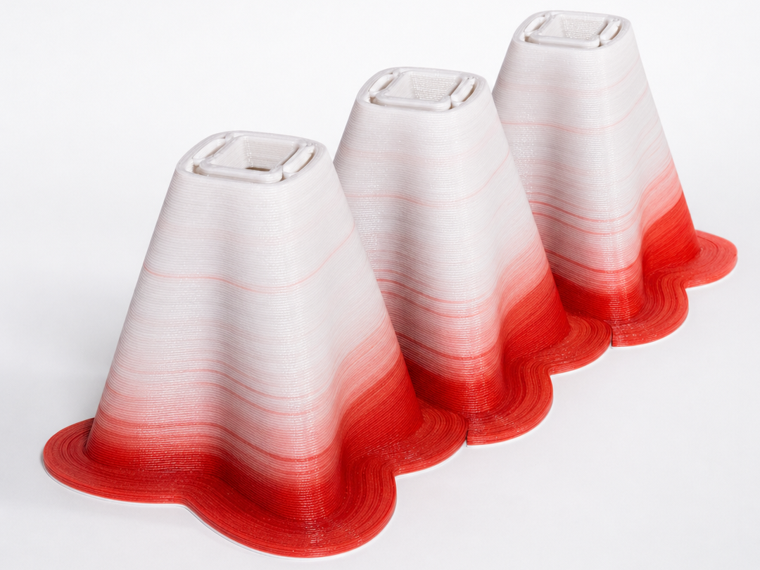 Série de cúpulas de luminária brancas com base em degradê vermelho, impressas em pellet