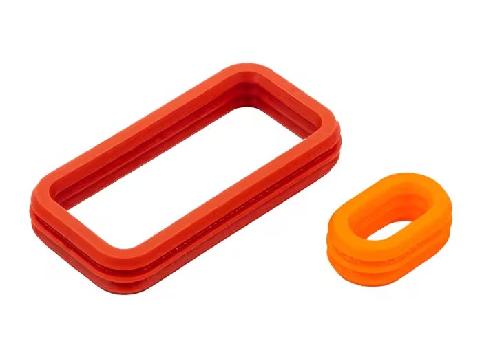 Vedações de silicone vermelha e laranja, exemplo de peça automotiva moldada em LSR