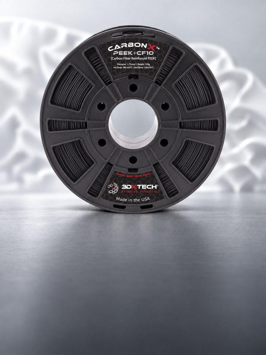 Bobina de filamento 3DXTech CarbonX PEEK+CF10 preta em estúdio cinza-claro